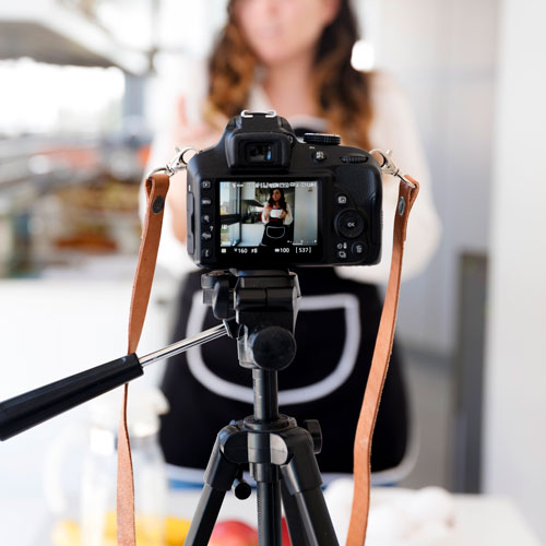 Camera on a tripod with a person in the background